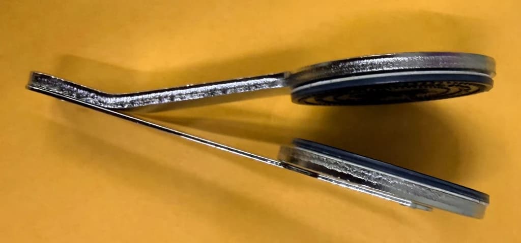 The shop’s removable embossing seal insert with two circular dies on a spring metal holder